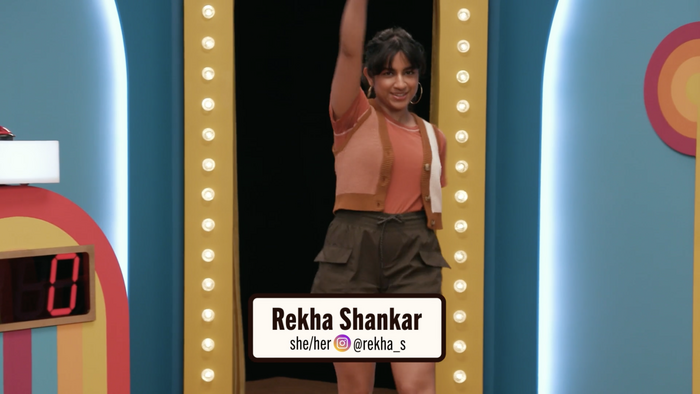 Screencap of Rekha Shankar’s entrance on S6EP7 Beat the Buzzer.
Rekha’s name, pronouns, and Instagram handle are all displayed in Trade Gothic Next.