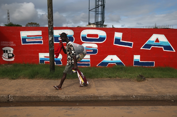 A man passes an Ebola awareness mural on October 2, 2014 in Monrovia, Liberia. More than 3,200 people have died in West Africa due to the epidemic.