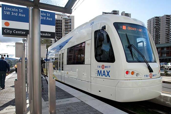 The TriMet logo on the new MAX car design introduced in 2015. Station signs use TheMix as well.