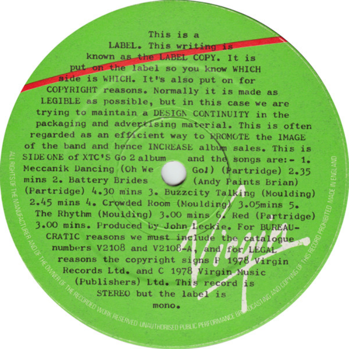 The same typographic treatment extends to the vinyl labels. The text on side one reads:


This is a LABEL. This writing is known as the LABEL COPY. It is put on the label so you know WHICH Bide is WHICH. It's also put on for COPYRIGHT reasons. Normally it is made as LEGIBLE as possible, but in this case we are trying to maintain a DESIGN CONTINUITY in the packaging and advertising material. This is often regarded as an efficient way to PROMOTE the IMAGE of the band and hence INCREASE album sales. […]  This record is STEREO but the label is mono.