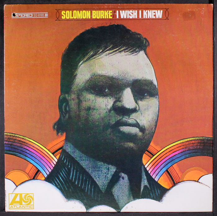 Front cover featuring Burke’s head in the clouds. Burke’s name (in yellow) and the album title (in white) are set in , surrounded by a decorative border.