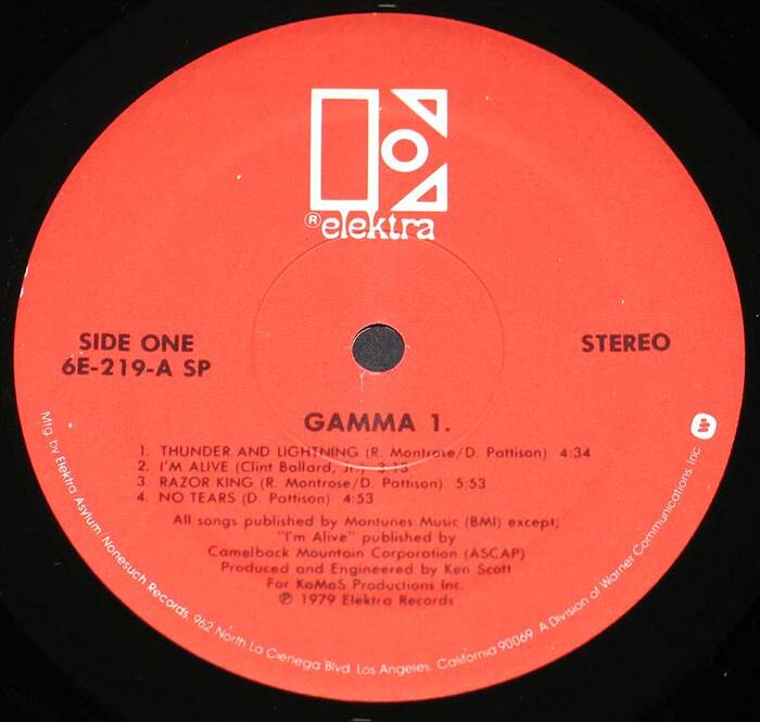 Label for Gamma’s 1979 self-titled Gamma 1 album. This label design, which is similar to the 1969–1970 design (only used on two LPs) but with a smaller logo, was first used in 1979 on Nino Rota’s soundtrack album for the film Hurricane.

Disc side indicator, catalog number, “STEREO” and band/album name set in  (bold; Bauer; 1927). Track list and credits also set in Futura (regular). Address info set in  (regular; ITC; 1970).