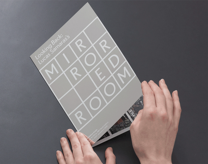 Takeaway exhibition guide for Looking Back: Lucas Samaras’s Mirrored Room printed on mirrored paper