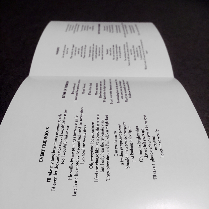 Inside the liner notes. Lyrics and song titles set in Weiss.