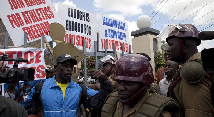 Kenya police stand outside the Kenya Athletic offices in Nairobi, Kenya, Monday, Nov. 23, 2015. A group of Kenyan athletes occupied the headquarters of the national track and field federation on Monday, demanding the removal of its top officials in a protest against doping and corruption.