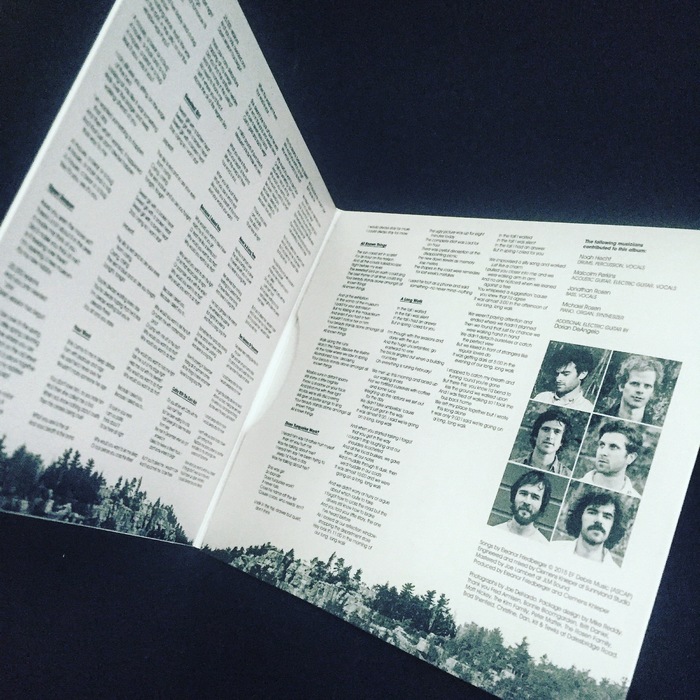 The inside panels, featuring lyrics set in multiple weights of ITC Avant Garde Gothic.
