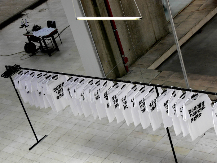 Nada Prlja — Strike. Installation, 2008. Industrial shirt railing, 10m, 100 hand painted T-shirts, 100 hangers. Image from the solo exhibition at the Museum of Contemporary Art, Skopje, Macedonia. Courtesy the artist