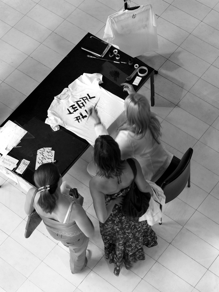 Nada Prlja — Strike. Installation, 2008. Industrial shirt railing, 10m, 100 hand painted T-shirts, 100 hangers. Image from the solo exhibition at the Museum of Contemporary Art, Skopje, Macedonia. Courtesy the artist