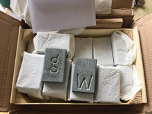 Art packages with chiseled letters