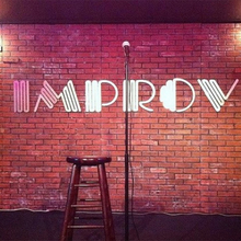 The Improv comedy club logo