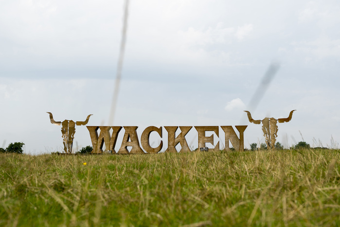Framed with skulls,&nbsp;the giant Wacken logo made of steel welcomes the visitors at the&nbsp;festival venue.
And yes, of course the kerning is wack.