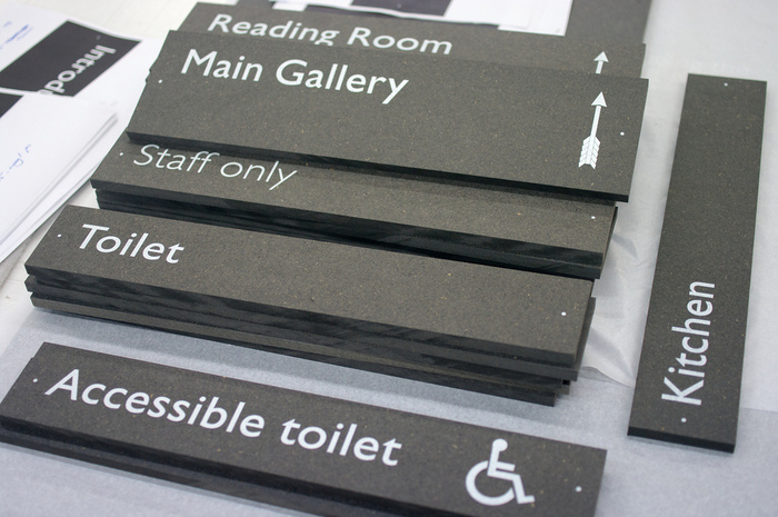 Checking graphics at BAF Graphics, Earlsfield, prior to installation.&nbsp;Signs are direct to media printed on black Valchromat; exhibition panels on white sprayed MDF.