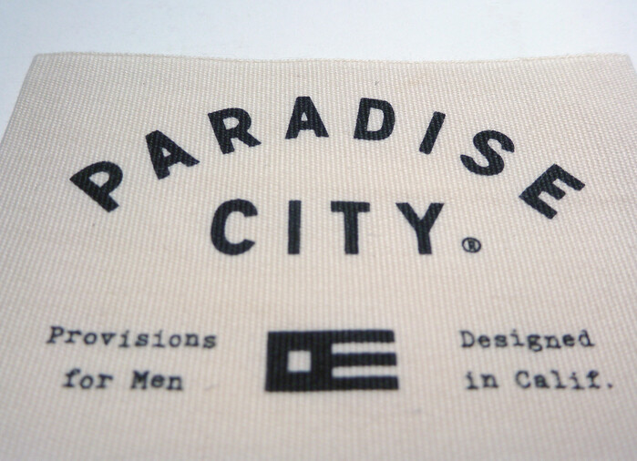 The design for the Paradise City logo took inspiration from international maritime signal flags. The emblem is comprised of the "P" and "C" ("Papa" and "Charlie") flags, merged together into one solid logoform.