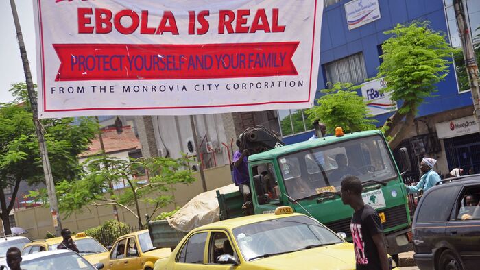 A banner reading, “Ebola is real. Protect yourself and your family” warns people of the Ebola virus in Monrovia, Liberia, on Aug. 2.