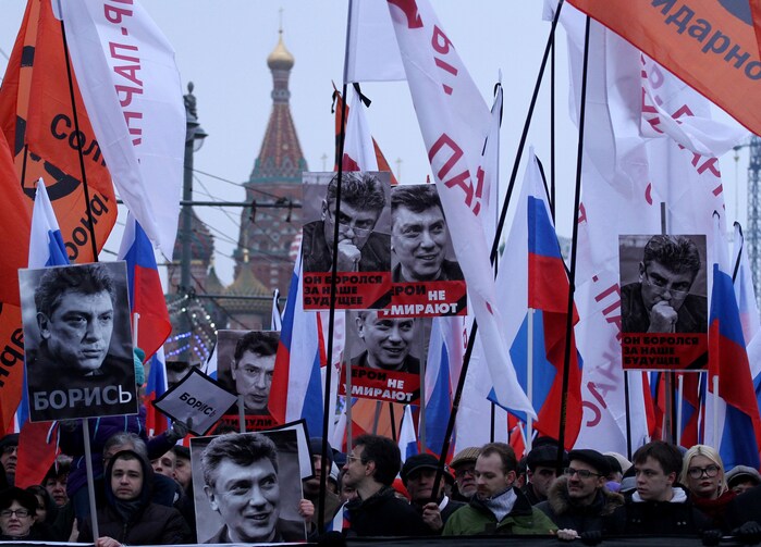 Russian opposition supporters carry photos of Boris Nemtsov in Moscow