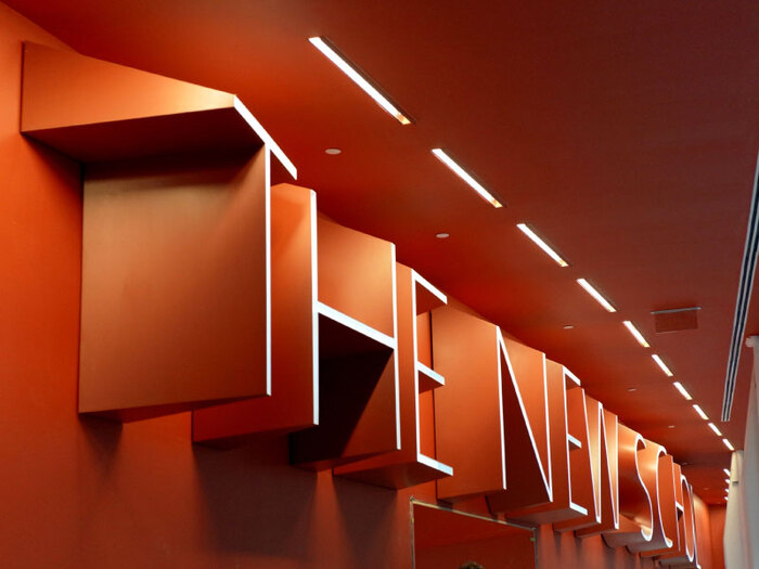 The five-foot-tall building sign in layered aluminum, manufactured and installed by Going Sign &amp; Servicing, decreases in depth from left to right. Each letter features a different perspective, imparting an uncanny effect to the whole.