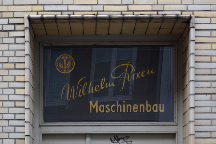 These gilded letters were reverse-painted on glass. They likely predate the larger sign and are a much better example for the art of sign-painting. No typeface was involved.