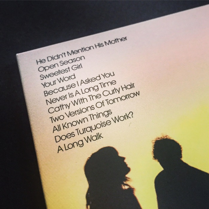 A close-up of the back cover, the upper-left corner features song titles set in ITC Avant Garde Gothic.