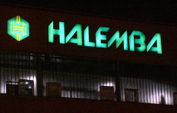 The now vanished sign at the office building, illuminated at night (c. 2006).