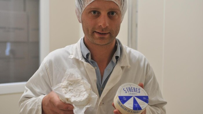 Charles Bréant, along with his four brothers, is the founder and producer of Le 5 Frères. He’s pictured in his production line proudly showing the camembert and its packaging.