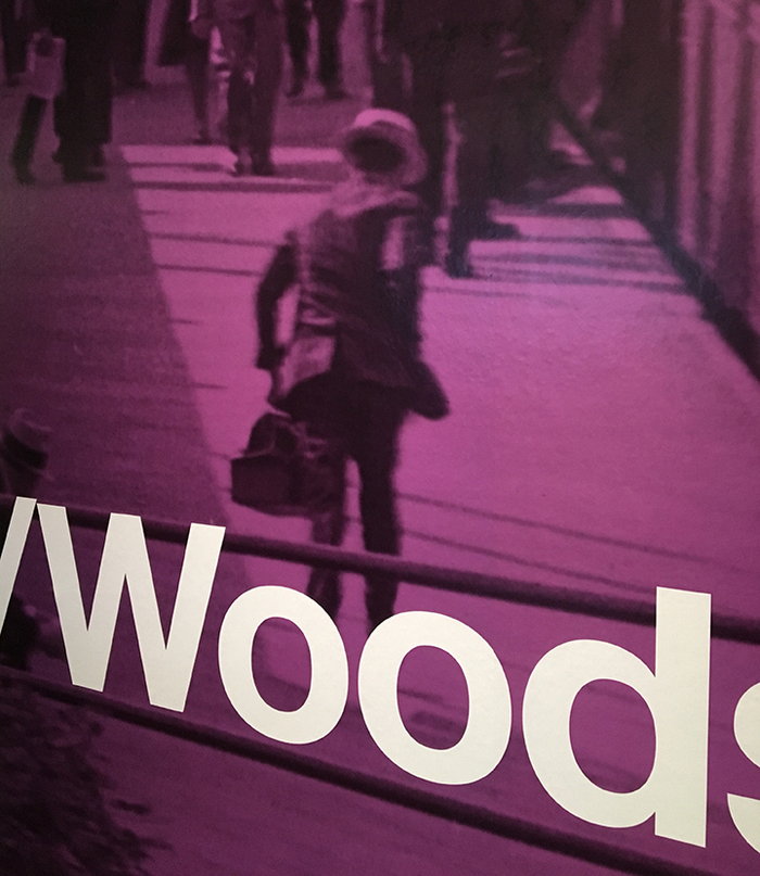 The section on the neighborhood of Woodside includes a photo of a man running for a train in the 1930s.