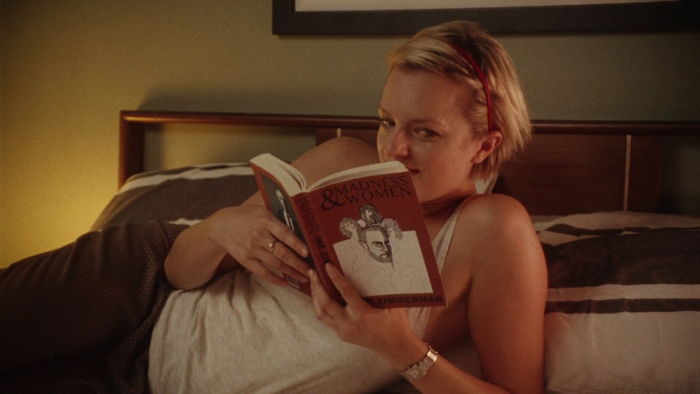 Ashley Kane reading another, newer edition of Madness &amp; Women, with a cover in a yet unidentified typeface.