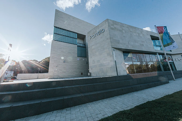 The logo in Omnes is shown in mounted metal letters at the building designed by Grimshaw Architects.