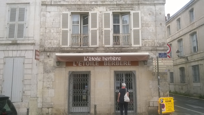 The typeface on the awning of restaurant L’étoile berbère is Harrington, a revival of a late-19th century typeface made by David Berlow and included in many Microsoft products.