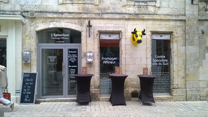 Fromagerie L’Épicurium offers cheese and wine. The type on the shop window is ITC Bauhaus.