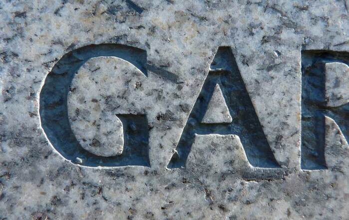 An example of an uppercase &ldquo;G&rdquo; and &ldquo;A&rdquo; carved in granite and infilled.