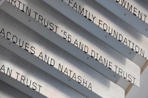 Donor signage cascades down the underside of a lobby staircase.