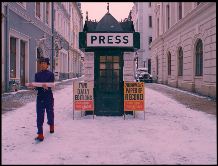 The word “PRESS” on the newsstand is written in FF DIN. The two signs below seem to use Toronto Gothic.