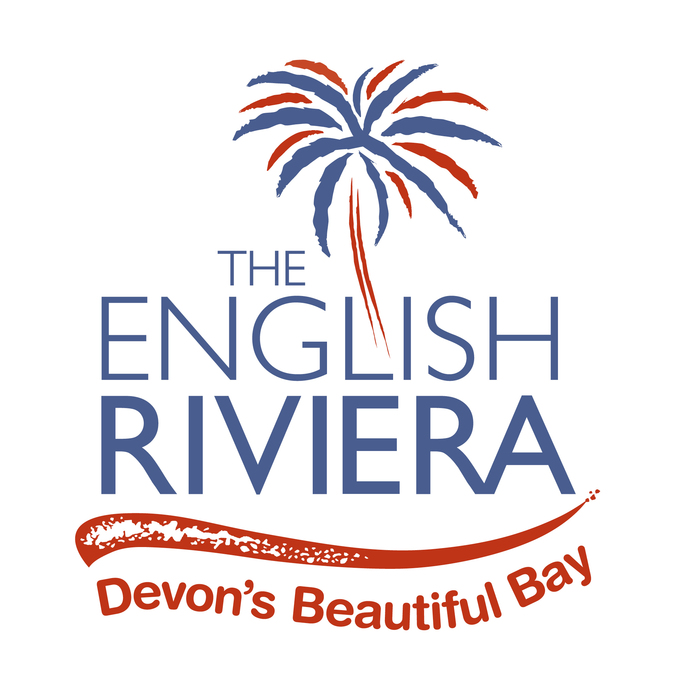 The current version (2018) features a weaker, asymmetric palm tree (or is fireworks?) in red and blue. The type is still in Gill Sans caps, but now in two weights, paired with Arial Rounded Bold, set on a wave.