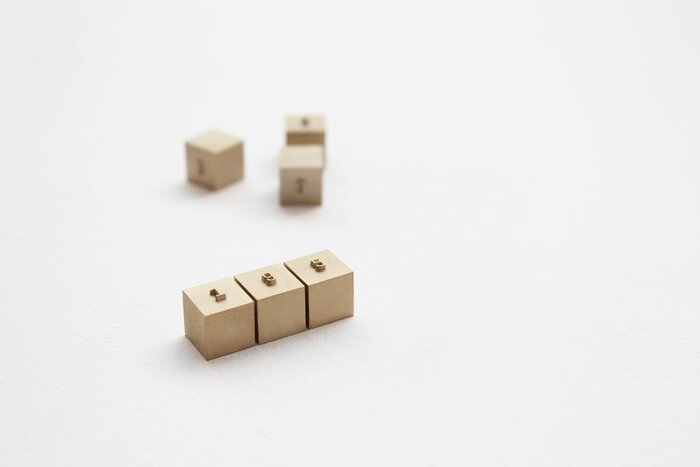 Solid brass price blocks, machined by a letterpress manufacturer in Geogrotesque.