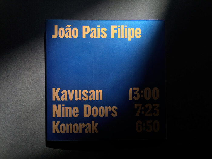 The track listing on the back cover uses custom lettering by Proto.
