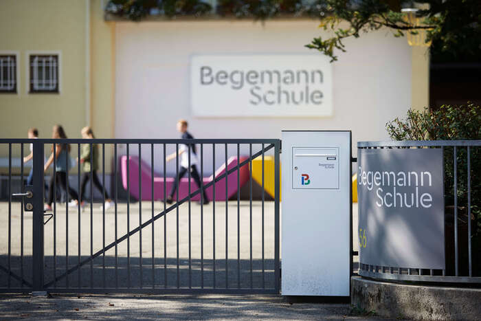 The two words of the school’s name are set flush right, with no hyphen.