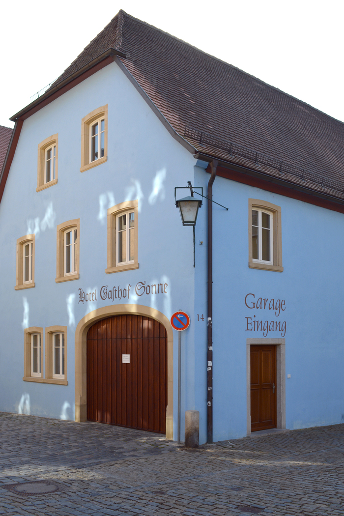 “Hotel Gasthof Sonne” is rendered in what looks like a hybrid of Fraktur and Old English letterforms. I don’t think this combination can be found in a font.