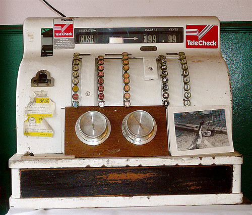 TeleCheck stickers on an old cash register at a butcher shop in Columbia City, Washington.