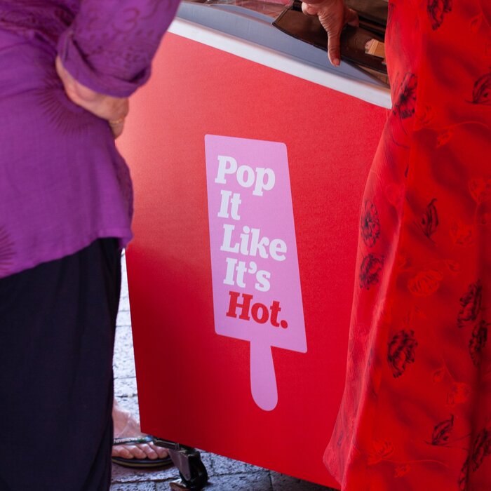The stacked words of PopCo’s advertising slogan are framed by a popsicle silhouette.