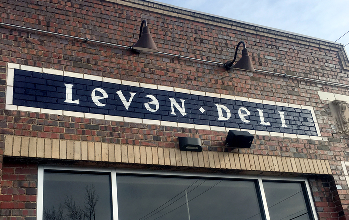 The name is rendered with an upside-down e to indicate an unstressed vowel, or schwah (ə). This form is echoed by using an enlarged lowercase form for the other E’s, too.