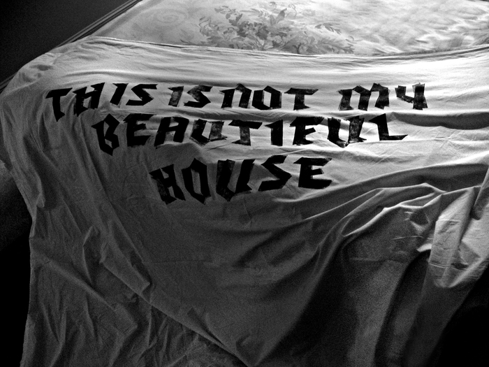 Nada Prlja — This is Not My Beautiful House. Letters pressed into the bed sheet by artist’s body while sleeping. Bed sheet 2x1.6m, printmaking ink, 7 hours. The text is taken from the lyrics to the song ‘Once in a lifetime’ by Talking Heads, 1981. Photo the artist.