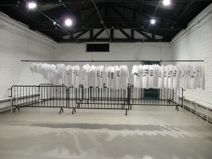 Nada Prlja — Strike. Installation, 2009. Industrial shirt railing, 10m, 70 hand painted T-shirts, 70 hangers. Image from the exhibition at MC Gallery, Zagreb, Croatia, 2009. Courtesy the artist