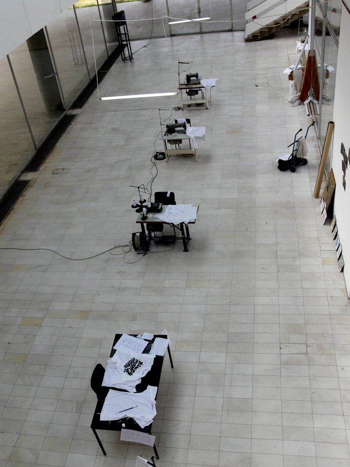 Nada Prlja — Strike. Installation, 2008. Industrial shirt railing, 10m, 100 hand painted T-shirts, 100 hangers. Image from the solo exhibition at the Museum of Contemporary Art, Skopje, Macedonia. Courtesy the artist
