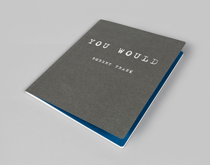 The textured cover in warm grey is followed by blue endpapers.