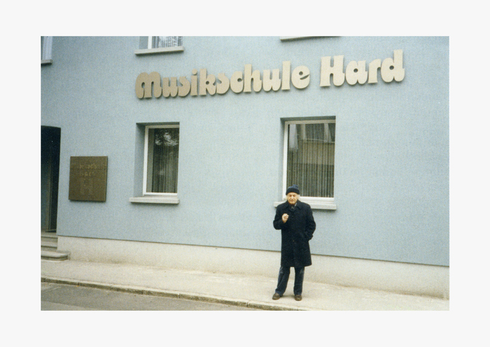 Othmar Motter in front of the building (undated), before the tree was planted that now obscures the sign.
Image courtesy of Triest Verlag.